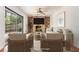Living room with brick fireplace, hardwood floors, and sliding glass door at 1260 Fork Creek Trl, Decatur, GA 30033