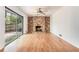 Cozy living room with hardwood floors, a brick fireplace, and sliding doors at 1260 Fork Creek Trl, Decatur, GA 30033