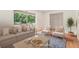 Bright living room boasts large windows, hardwood floors, and comfortable seating at 1260 Fork Creek Trl, Decatur, GA 30033