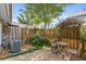 Private patio with charming seating, lush greenery, and a wooden fence for a peaceful retreat at 136 Peachtree Memorial Nw Dr # Ct-6, Atlanta, GA 30309
