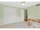 Bright bedroom featuring wainscoting, a ceiling fan, and ample closet space for storage and comfort at 136 Peachtree Memorial Nw Dr # Ct-6, Atlanta, GA 30309