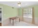 This bedroom features a ceiling fan, natural light, and a desk, creating a welcoming and functional space at 136 Peachtree Memorial Nw Dr # Ct-6, Atlanta, GA 30309