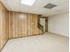 Finished basement area with carpet and wood paneling, perfect for a recreation room at 1420 Pilgrim Rd, Cumming, GA 30040