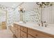 Bathroom boasts a double sink vanity, ample counter space, and unique wallpaper at 1420 Pilgrim Rd, Cumming, GA 30040