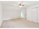 Spacious bedroom with neutral carpet, ample closet space, and a ceiling fan for comfort at 1420 Pilgrim Rd, Cumming, GA 30040