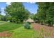 Landscaped front yard and exterior elevation of the house and carport at 1420 Pilgrim Rd, Cumming, GA 30040