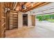 Open garage space with shelving, access to the outdoors, and a smooth concrete floor at 1420 Pilgrim Rd, Cumming, GA 30040