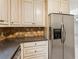 Kitchen with stainless appliances, granite countertops, plentiful cabinets, and tile backsplash at 1420 Pilgrim Rd, Cumming, GA 30040