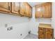 Functional laundry room with wood cabinets, a countertop, and connections for laundry machines at 1420 Pilgrim Rd, Cumming, GA 30040