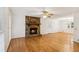 Bright and spacious living room with a stone fireplace and hardwood flooring at 1420 Pilgrim Rd, Cumming, GA 30040