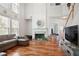 Cozy living room with hardwood floors, fireplace, large windows and staircase to second floor at 3616 Myrtlewood Nw Ct, Kennesaw, GA 30144