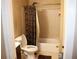 Cozy bathroom featuring a shower-tub combo with decorative curtain and neutral tile surround at 636 North Ave # 11E, Jonesboro, GA 30236
