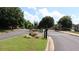 Gated entrance to Rexmill Square featuring lush green landscape and a private property sign at 636 North Ave # 11E, Jonesboro, GA 30236