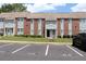 Exterior view of brick and vinyl townhouse with lawn and parking, showcasing its exterior design at 636 North Ave # 11E, Jonesboro, GA 30236