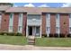 Exterior of brick and vinyl townhouse with well-maintained lawn and trimmed bushes at 636 North Ave # 11E, Jonesboro, GA 30236