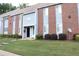 Close-up of a townhouse with a well-manicured lawn and bushes, showcasing its charming appeal at 636 North Ave # 11E, Jonesboro, GA 30236