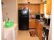 Compact kitchen featuring wood cabinets and essential appliances, perfect for efficient cooking at 636 North Ave # 11E, Jonesboro, GA 30236