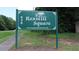 Entrance to Rexmill Square featuring a lush green lawn with landscaping and a sign with community information at 636 North Ave # 11E, Jonesboro, GA 30236