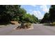 Community street view featuring lush landscaping and a sign reminding residents to keep the Rexmill Square neighborhood clean at 636 North Ave # 11E, Jonesboro, GA 30236