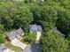 Overhead view of a home nestled among lush trees, showcasing its spacious lot and well-maintained surroundings at 115 Township Ct, Woodstock, GA 30189