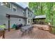 Outdoor deck area with patio set and grill, backing to the woods at 115 Township Ct, Woodstock, GA 30189