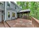 Multi-level backyard deck with patio set overlooking wooded area at 115 Township Ct, Woodstock, GA 30189