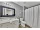Cozy bathroom features a white vanity, framed mirror, and shower with a white curtain at 115 Township Ct, Woodstock, GA 30189