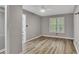 Light and airy bedroom boasts modern decor, a ceiling fan, and lots of light at 115 Township Ct, Woodstock, GA 30189