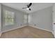 Bright bedroom features wood-look flooring, ceiling fan, and natural light at 115 Township Ct, Woodstock, GA 30189