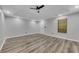 Bedroom features a tray ceiling, wood-look flooring, and bright recessed lighting at 115 Township Ct, Woodstock, GA 30189
