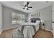 Charming bedroom features stylish decor, gray headboard, and a ceiling fan at 115 Township Ct, Woodstock, GA 30189