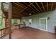 View of large, covered patio area with wood ceiling, overlooking the backyard woods at 115 Township Ct, Woodstock, GA 30189