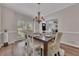Elegant dining room featuring hardwood floors, wainscoting, and a stylish chandelier at 115 Township Ct, Woodstock, GA 30189