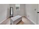 Well-lit dressing room with a large tufted ottoman, full-length mirror, and hardwood floors at 115 Township Ct, Woodstock, GA 30189