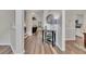 Bright entryway with hardwood floors, console table, and views into the living and dining areas at 115 Township Ct, Woodstock, GA 30189
