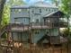 Rear exterior view of the home from the backyard, showing the multi-level deck at 115 Township Ct, Woodstock, GA 30189