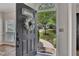 View from the front door of landscaped yard, trees, walkway, and neighborhood street at 115 Township Ct, Woodstock, GA 30189
