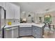 Open-concept kitchen with island, white cabinets, stainless steel appliances, and casual dining area at 115 Township Ct, Woodstock, GA 30189