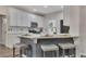 Kitchen island with white countertop, seating, and white cabinets, providing a casual dining space at 115 Township Ct, Woodstock, GA 30189