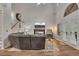 Bright living room with vaulted ceilings, hardwood floors, fireplace, and French doors to the backyard at 115 Township Ct, Woodstock, GA 30189