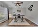 Home office with neutral walls, wood floors, a ceiling fan, and a large window for natural light at 115 Township Ct, Woodstock, GA 30189