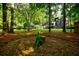 Expansive backyard featuring a modern home design, mature trees, and artistic landscaping elements at 1510 Chevron Dr, Sandy Springs, GA 30350