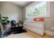 Stylish bedroom area featuring hardwood floors, a modern dresser, and a bright window at 1510 Chevron Dr, Sandy Springs, GA 30350
