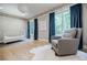 Cozy Bedroom with light hardwood floors, a rocking chair, and an elegant area rug at 1510 Chevron Dr, Sandy Springs, GA 30350