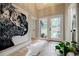 Bright foyer featuring tiled floors, modern art, and a view to the outdoors through glass paneled doors at 1510 Chevron Dr, Sandy Springs, GA 30350