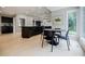 Eat-in kitchen featuring modern cabinets, stainless appliances, a kitchen island, and views to the backyard at 1510 Chevron Dr, Sandy Springs, GA 30350