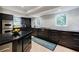 Well-lit kitchen featuring dark cabinetry, stainless steel appliances, and lots of counter space at 1510 Chevron Dr, Sandy Springs, GA 30350