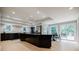 Well-lit kitchen featuring an island, stainless steel appliances, modern cabinetry, and views to the backyard deck at 1510 Chevron Dr, Sandy Springs, GA 30350