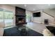Stylish living room featuring a stone fireplace, tile floors, and sliding glass doors leading to the pool area at 1510 Chevron Dr, Sandy Springs, GA 30350