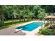 Backyard featuring a sparkling in-ground swimming pool, diving board, and surrounding lush landscaping at 1510 Chevron Dr, Sandy Springs, GA 30350